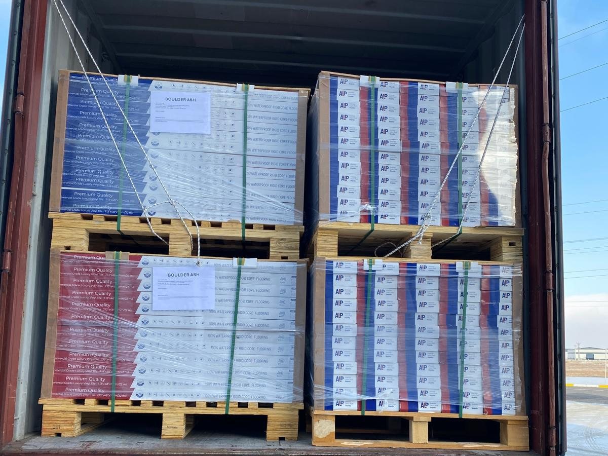 Shipping container loaded with Alupedia flooring pallets, ready for export